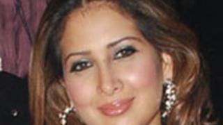 Kim Sharma strikes a pose during the shooting of an item song