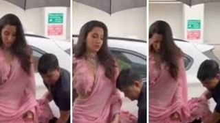 Nora Fatehi gets trolled for having her security guard hold her sari during heavy rains