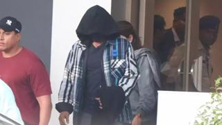 Shah Rukh Khan covers his face as he returns from Vaishno Devi