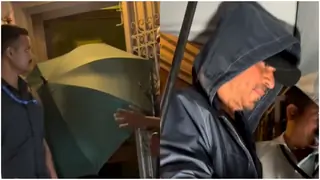 Shah Rukh Khan Hides Behind An Umbrella During His Outing; Fans Ask the reason behind his tight security