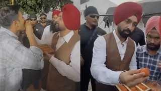 Diljit Dosanjh feeds ladoos to Varun Dhawan, Ahan Shetty, and others as he wraps up his Border 2 shoot; Watch