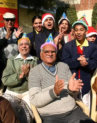 School children celebrating christmas with senior citizens at a old age home in a programme orginizied by help age India in New Delhi Thumbnail