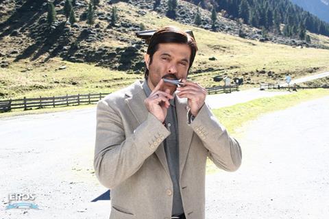 Anil Kapoor playing a harmonica