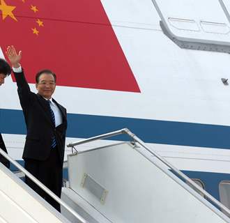 Chinese Premier Wen Jiabao waves as he arrives for a three-day visit to India, in New Delhi, India, Wednesday, Dec. 15, 2010. Wen arrived Wednesday as part of efforts to build trust between the rival neighbors amid lingering disputes over ...