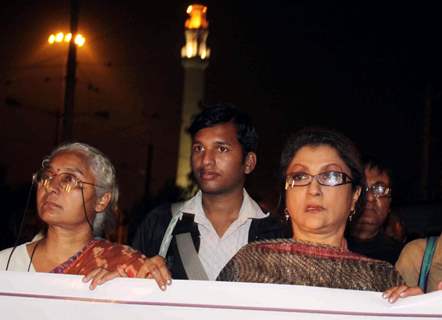 Eminent Tollywood actress Aparna Sen (R) famous social activist Medha Pathekar takes part in a protest rally to free Dr. Binayak Sen from jail in Kolkata on Monday late night. .