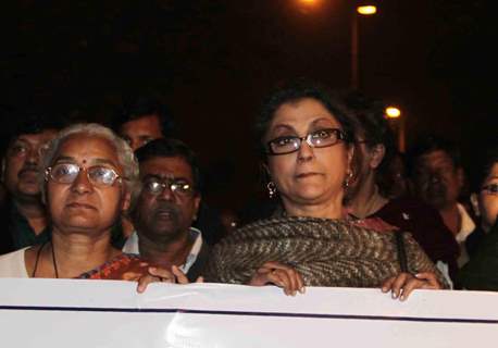 Eminent Tollywood actress Aparna Sen (R) famous social activist Medha Pathekar takes part in a protest rally to free Dr. Binayak Sen from jail in Kolkata on Monday late night. .