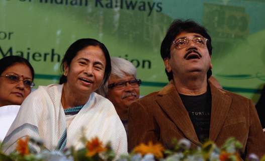 Railway minister Mamata Banerjee shares a light moment with eminent tollywood actor Chranjit(R) during a foundation stone laying function to confer the status of 17th Indipendent Zonal Railway in Kolkata and commencement of work for Joka-BBD Bag ...