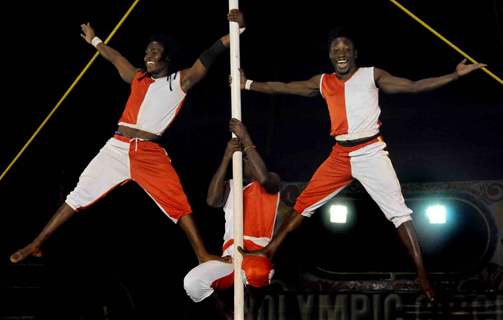 Kolkata: Circus performers perform skills during the rod balance round in Olympic Circus held in Kolkata in the eve of up coming New Year 2011, on Friday. .