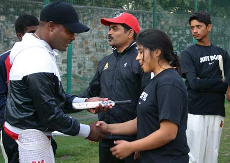 West Indies cricketerBrian Lara gives tips to young cricketers at Ferozshah Kotla  stadium in New Delhi on Tuesday. .