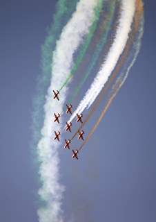 Surya Kiran team of Indian Air Force showing aerobatics at Aero India '11' in Bangalore. .