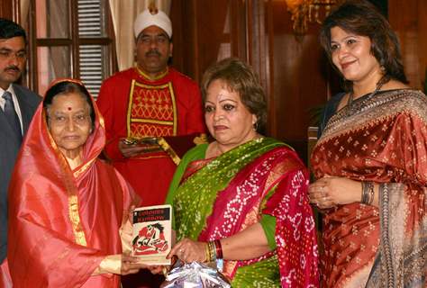 President Pratibha Patil receiving the first copy of the book ''Colours of My Rainbow'' from vice Presidents wife Salma Ansari at Rashtrapati Bhavan, on Monday. .