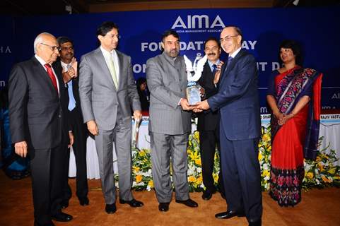Anand Sharma,Minister for Commerce and Industry, Government of India presenting the AIMA - JRD Tata Corporate Leadership Award to Adi Godrej, Chairman, Godrej Group at the AIMA Foundation Day. Others in the picture from (l to r), Dr. Ram ...