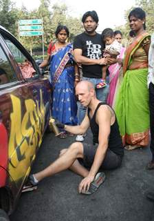 German graffiti artist Wok spray painting on a car outside the German Embassy  to celebrate 60 years of Indo-German diplomatic relations ,in New Delhi on Thursday. .