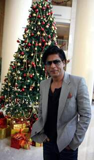 Shah Rukh Khan posing with a Christmas Tree in a Christmas Special photo shoot at Hotel Trident