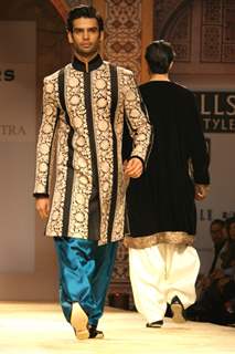 A model displays a creation by designer Manish Malhotra at the Wills Lifestyle India Fashion week 2012,in New Delhi on Friday. .