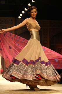 A model displays a creation by designer Manish Malhotra at the Wills Lifestyle India Fashion week 2012,in New Delhi on Friday. .