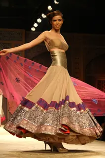 A model displays a creation by designer Manish Malhotra at the Wills Lifestyle India Fashion week 2012,in New Delhi on Friday. .