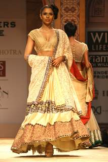 A model displays a creation by designer Manish Malhotra at the Wills Lifestyle India Fashion week 2012,in New Delhi on Friday. .