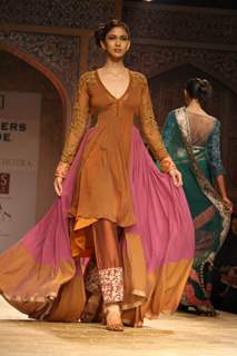 A model displays a creation by designer Manish Malhotra at the Wills Lifestyle India Fashion week 2012,in New Delhi on Friday. .