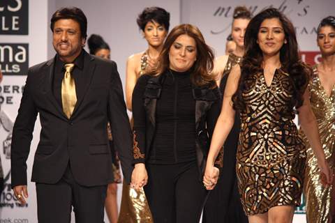 Bollywood actor Govinda and daughter Narmada with designer ReynuTaandon at the  Wills Lifestyle India Fashion week 2012,in New Delhi on Sunday. .