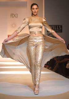 Bollywood actor Nargis Fakhri displays a creation by designer Sakshee Pradhan at the  Wills Lifestyle India Fashion week 2012,in New Delhi on Sunday. .