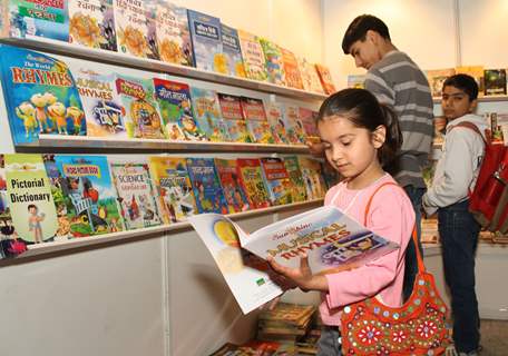 Children at a book stall during the 20 th World Book Fair, in New Delhi on Saturday. .