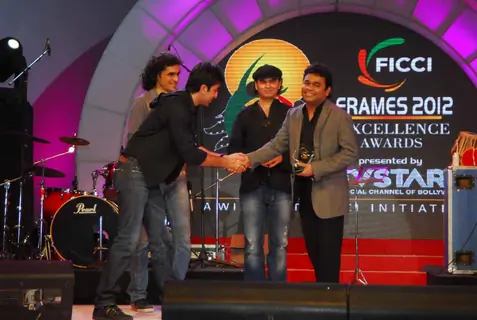Ranbir Kapoor, Imtiaz Ali and Mohit Chauhan present AR Rahman with an award at the FICCI Frames Excellence Awards 2012. .