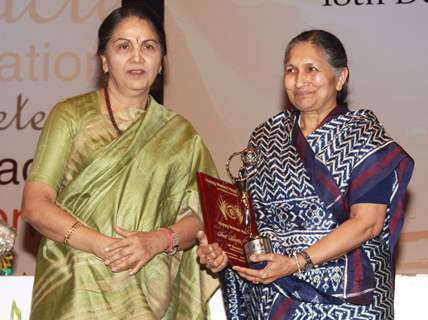 Naveen Jindal's mother Savitri Jindal receiving award from Justice Gyan Sudha Misra on &quot;Happy Woman's Day&quot; celebration at Balayogi Auditorium at Parliament House in New Delhi. (Photo: IANS/Amlan)