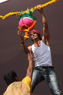 Arjun Rampal seen in as a Govinda, climbing up to the Dahi Handi