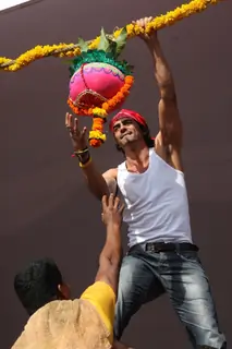 Arjun Rampal seen in as a Govinda, climbing up to the Dahi Handi