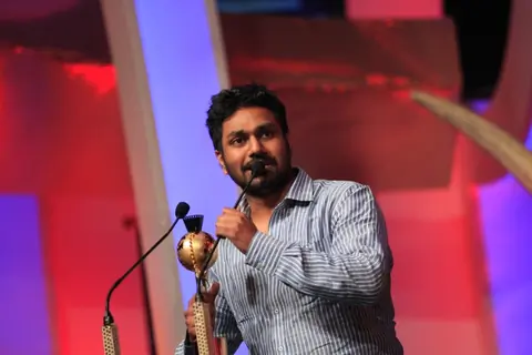 Mithoon Sharma receiving the award for Most popular song at the SAIFTA award ceremony