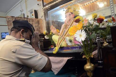 A constable seeks blessings of Lord Ganesha