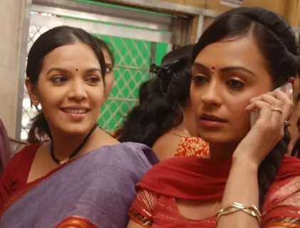 Nanda and Bubly sitting on a train