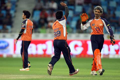 The Veer Marathi team celebrates a wicket taken