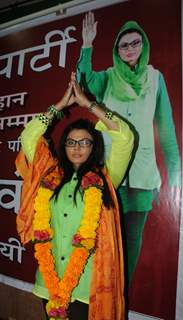 Rakhi Sawant with her political party banner of 'Rashtriya Aam Party'