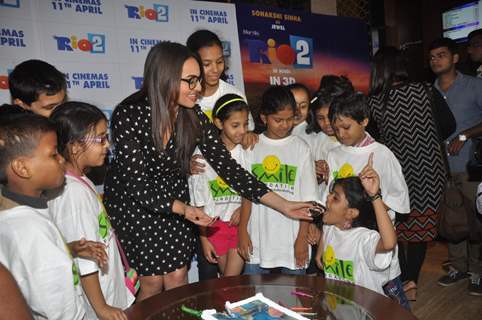 Sonakshi Sinha treats children to cake at a special screeing of Rio 2