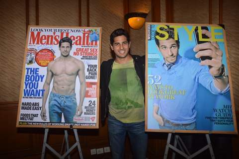 Sidharth Malhotra poses alongsidethe cover of Men's Health and Style