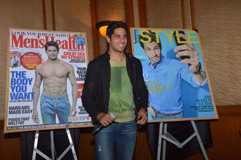 Sidharth Malhotra poses alongsidethe cover of Men's Health and Style