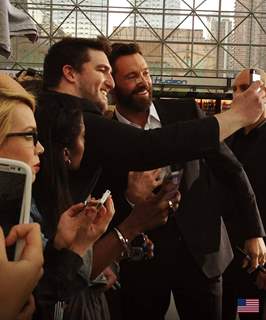 Hugh Jackman poses for a selfie with his fan at the Premiere