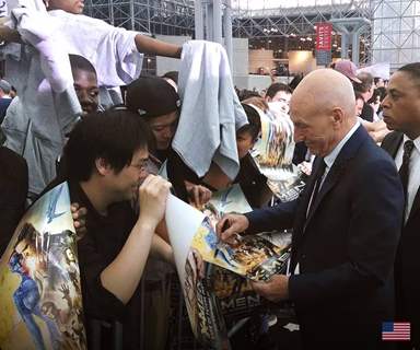 Patrick Stewart signs posters for his fans at the Premiere