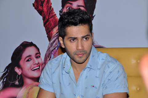 Varun Dhawan posing smartly at the Press Meet