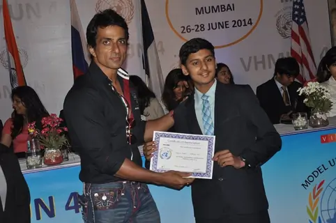 Sonu Sood giving certificate to student at  MUNA event .