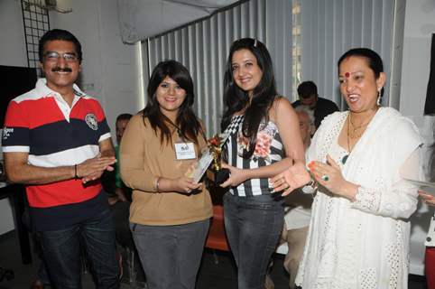 Bharat and Dorris Godambe with Amy Billimoria felicitating a Student
