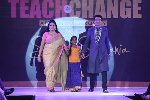 Guests with a child walk the ramp at the Teach for Change 2014 Fashion Show