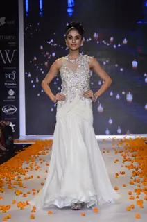 A model walks the ramp as a bride's maid at the IIJW 2014 - Day 2