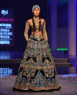 A model walks the ramp at the Indian Couture Week - Day 4