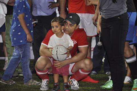 Aamir khan holds a kid at Charity Football Match