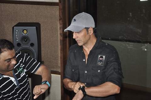 Akshay Kumar checks for his watch at the Promotion of It's Entertainment