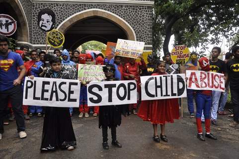 Children hold the posters at Superhero Mill Event