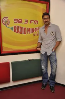 Ajay Devgn poses for the media at Radio Mirchi Studio